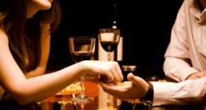 Man and woman at the restaurant - holding hands together Man and woman at the restaurant - holding hands together